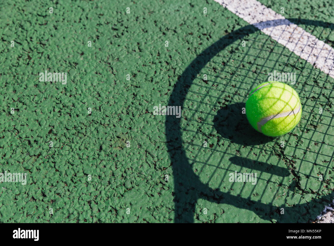 Tennis racket shadow and ball on green tennis court Stock Photo Alamy