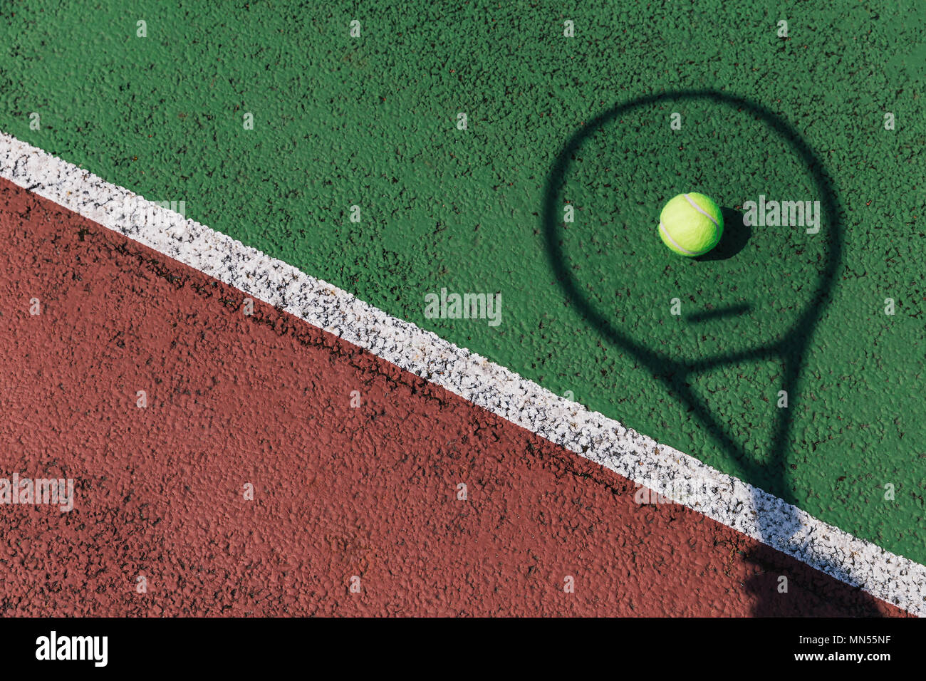 Tennis racket shadow and ball on green tennis court Stock Photo Alamy