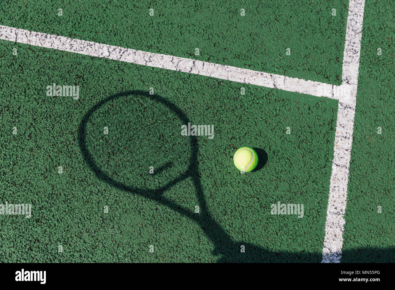 Tennis racket shadow and ball on green tennis court Stock Photo Alamy