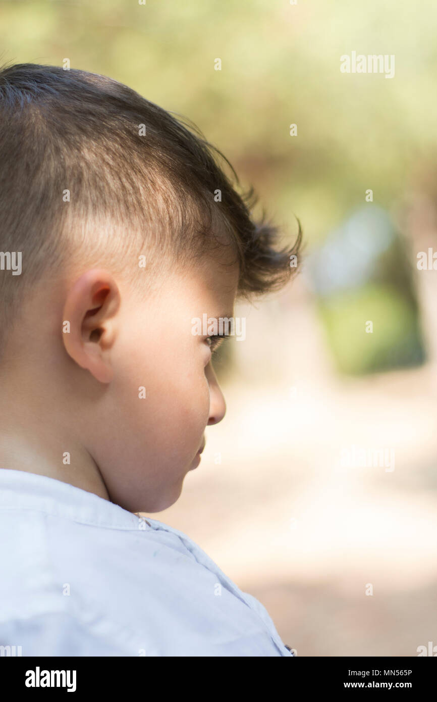 SIde view of a sad boy looking away Stock Photo