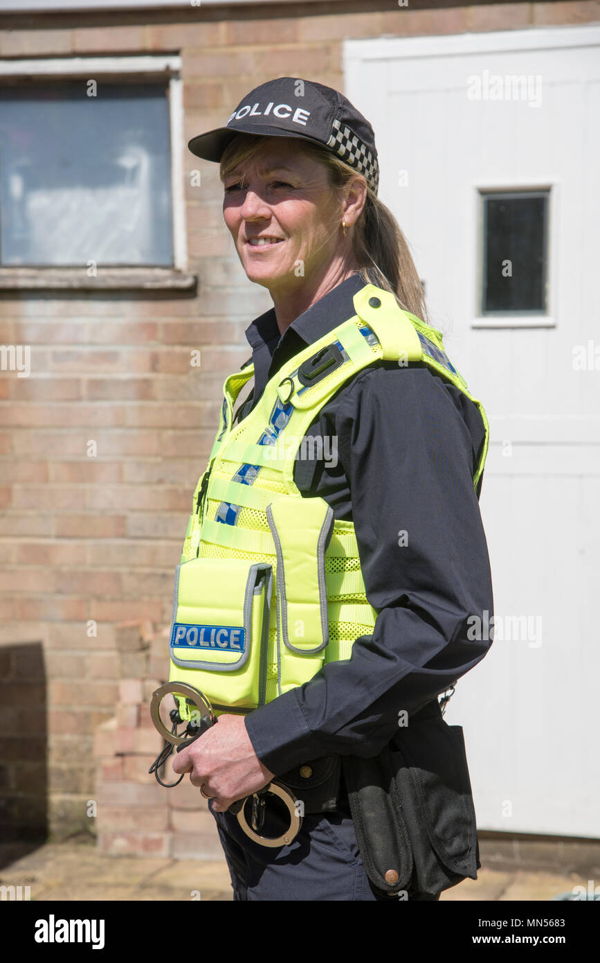 Portrait of a uniformed police officer holding handcuffs Stock Photo