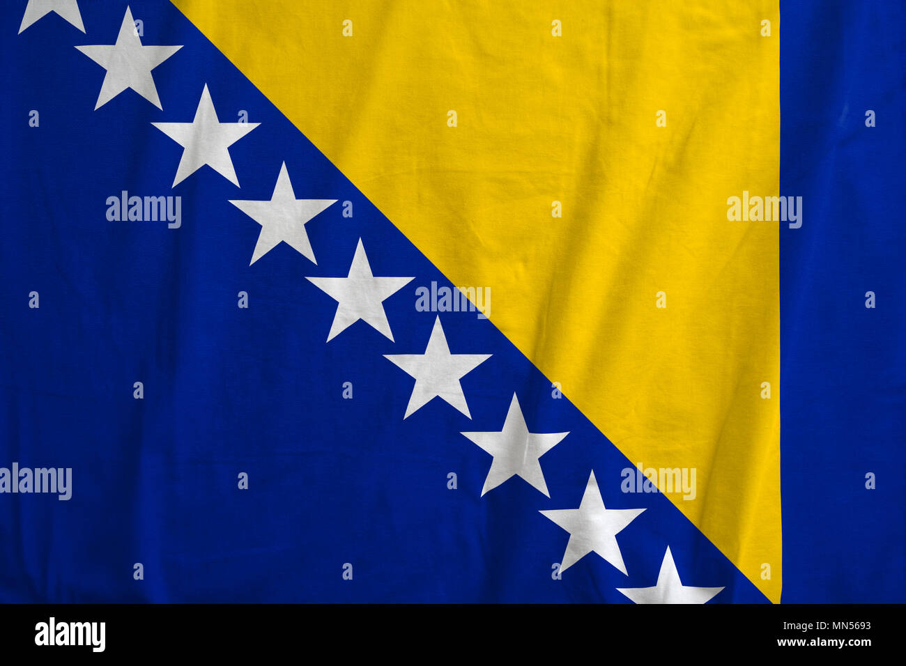 Bosnia and Herzegovina flag blowing in the wind. Background texture. Stock Photo