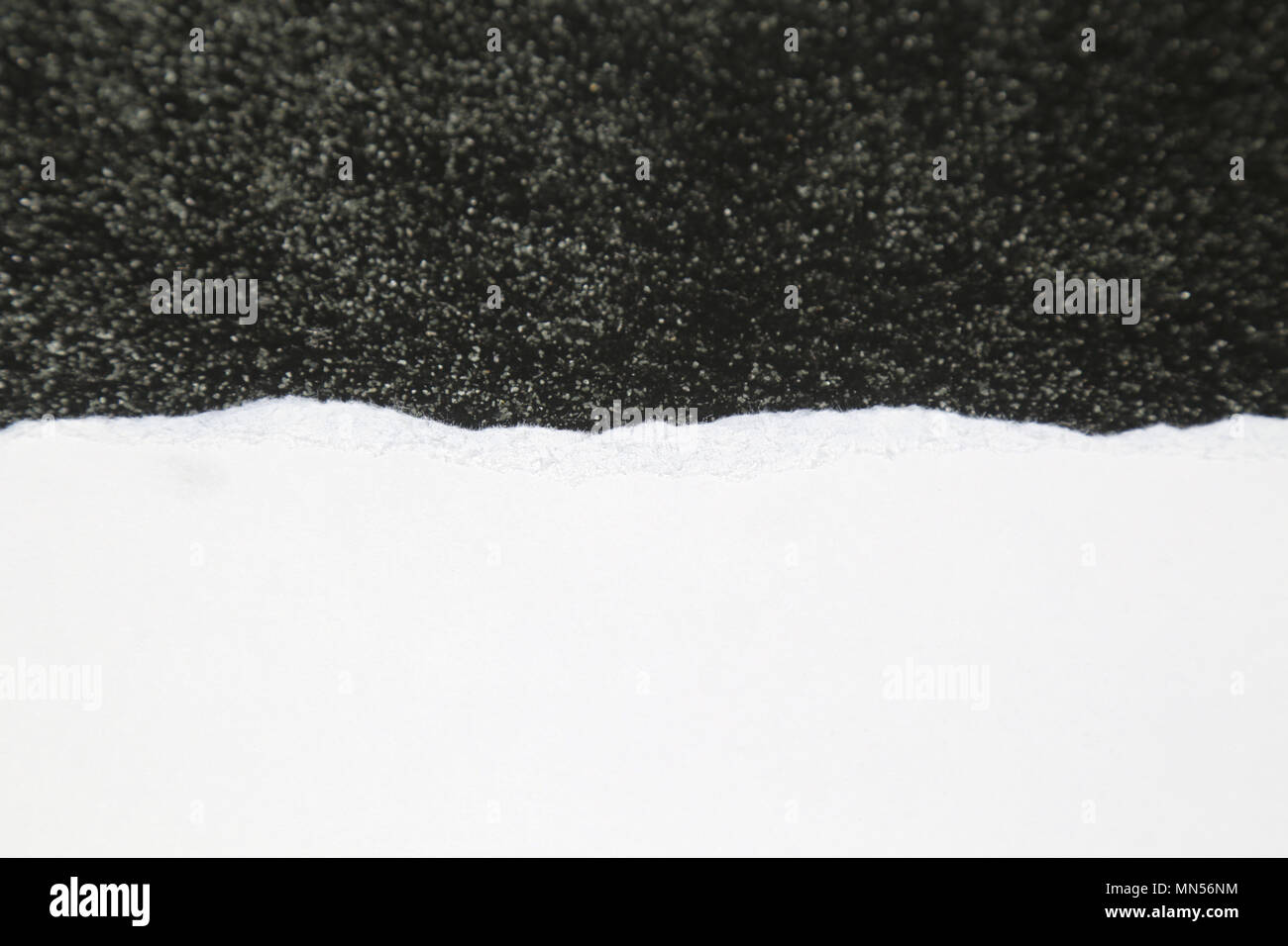 Torn White Paper on Rough Dark Textured background Stock Photo