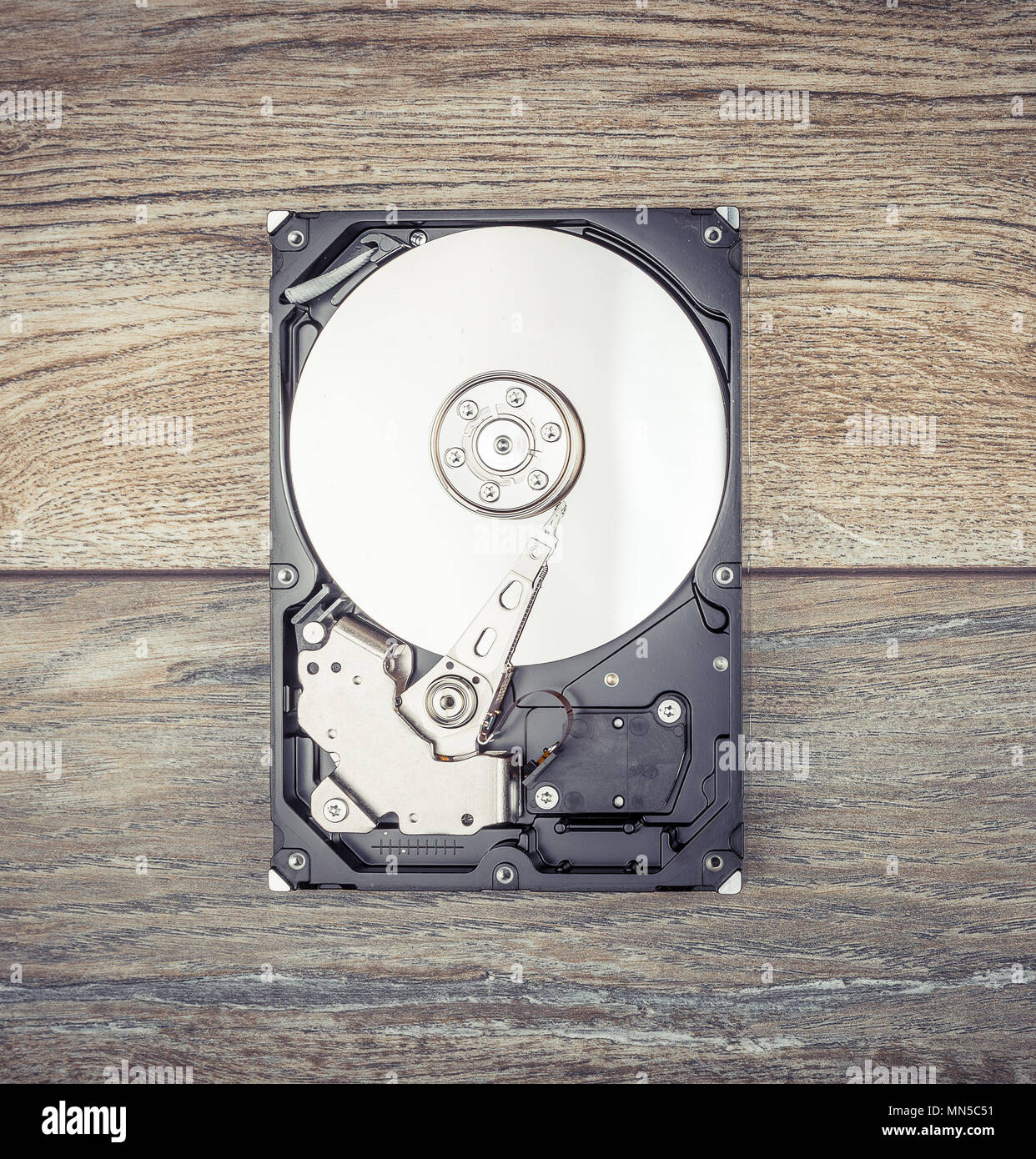 Disassembled Hard drive on wooden table Stock Photo