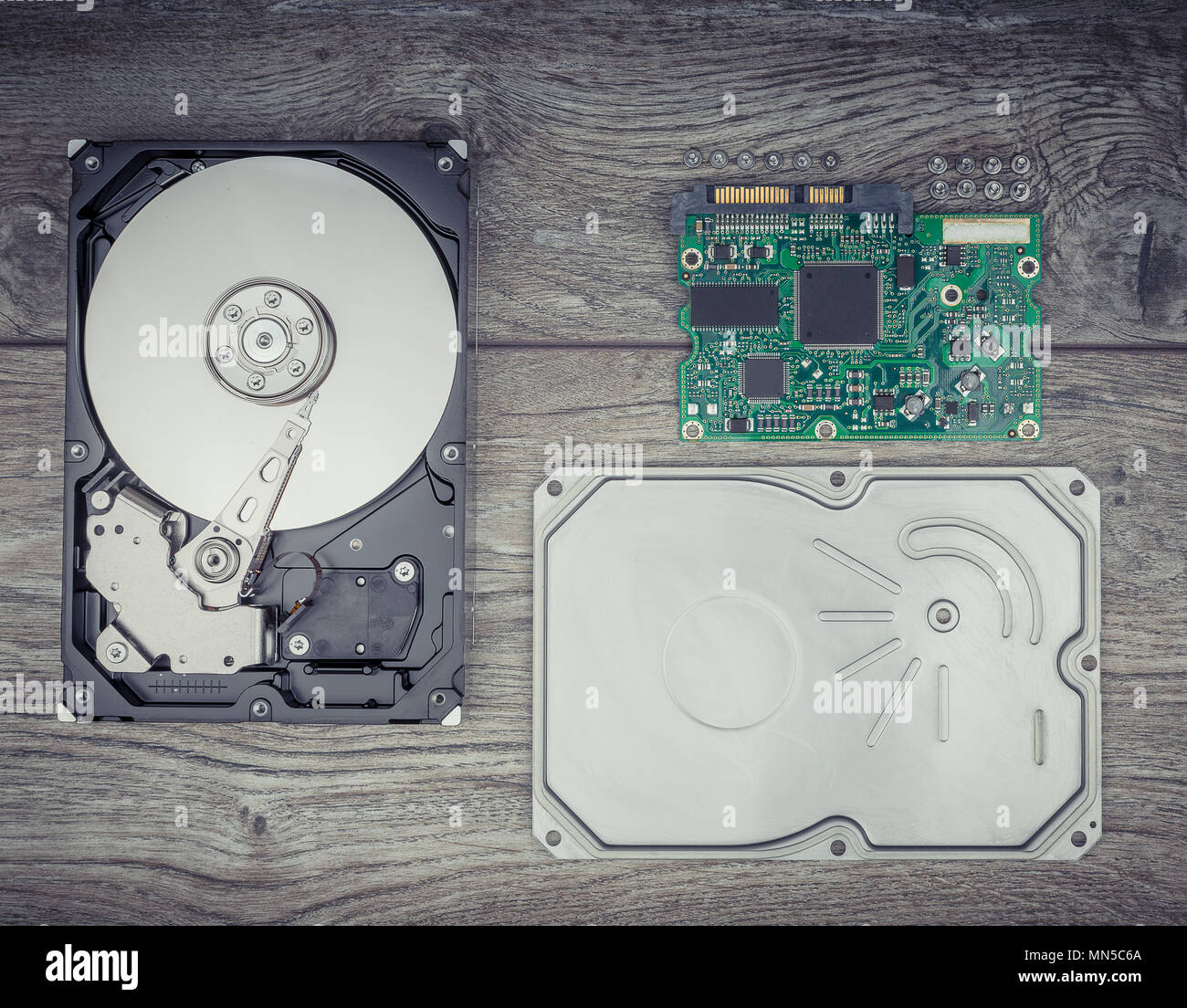 Disassembled Hard drive on wooden table Stock Photo