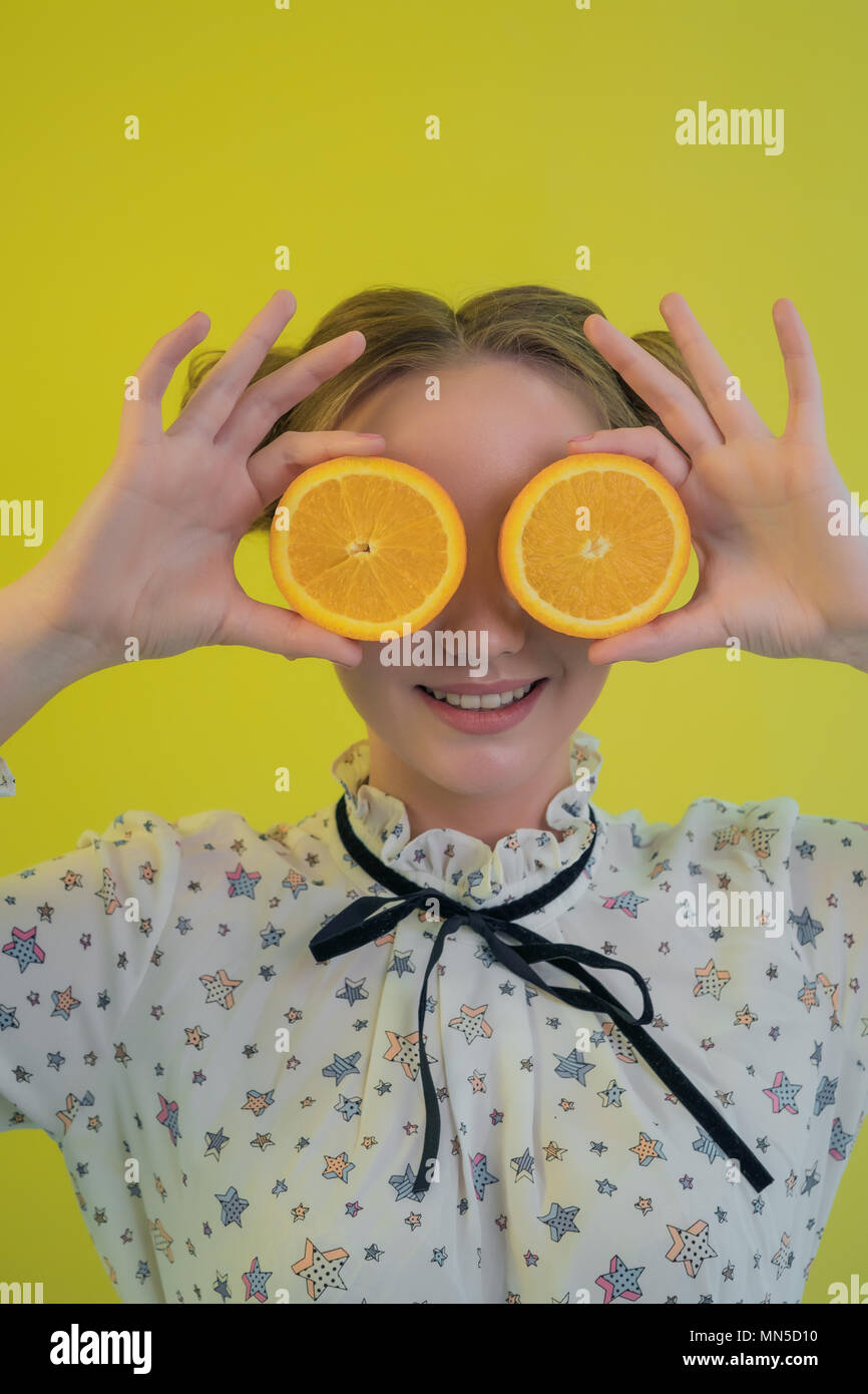Portrait of a charming young girl in shirt amusing closes his eyes ...