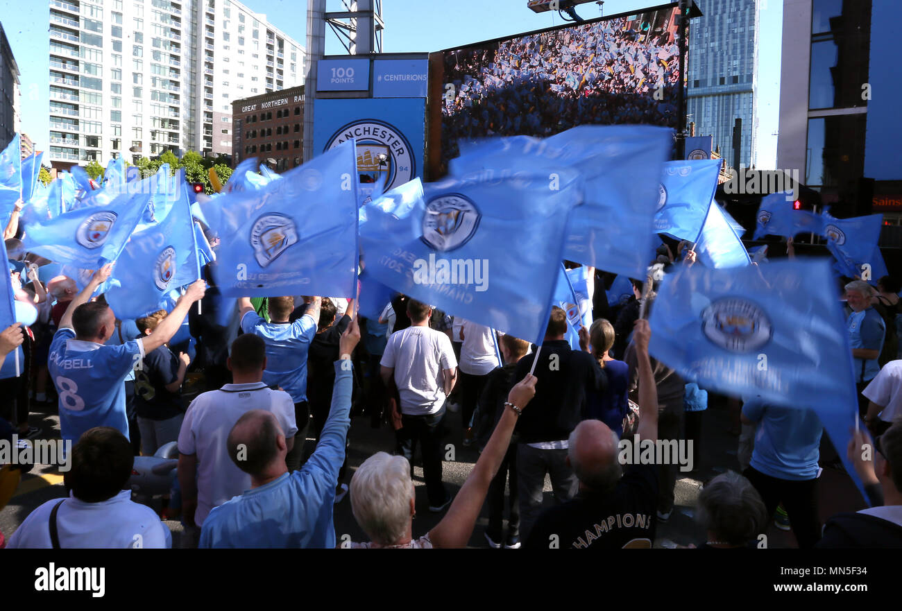 Manchester City fans wave flags during the Premier League champions trophy parade, Manchester. Stock Photo