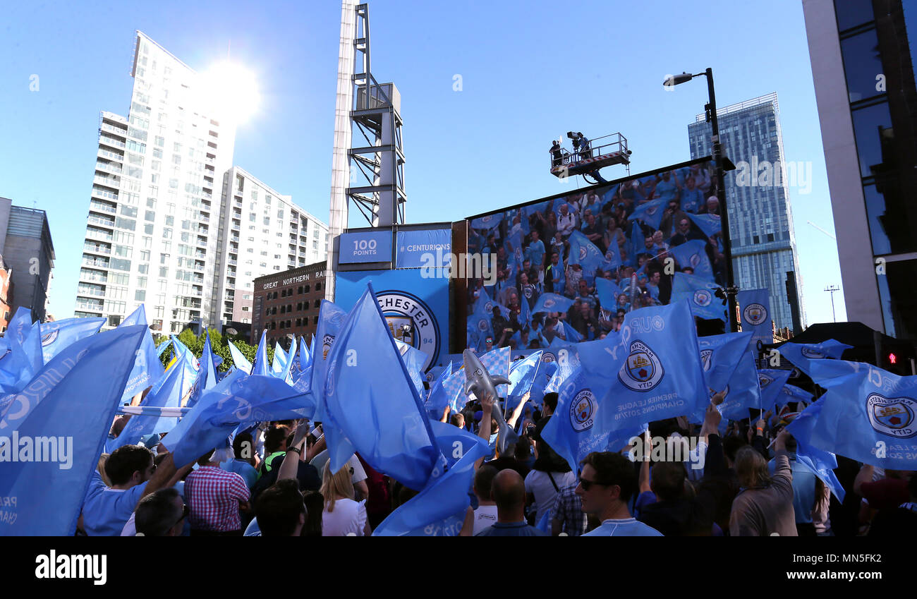 Manchester City fans wave flags during the Premier League champions trophy parade, Manchester. Stock Photo