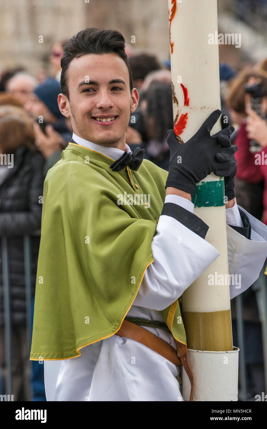 Young man, confraternity member, wearing tunic and pellegrina, holding cero pasquale (Easter candle) on Easter Sunday in Sulmona, Abruzzo, Italy Stock Photo