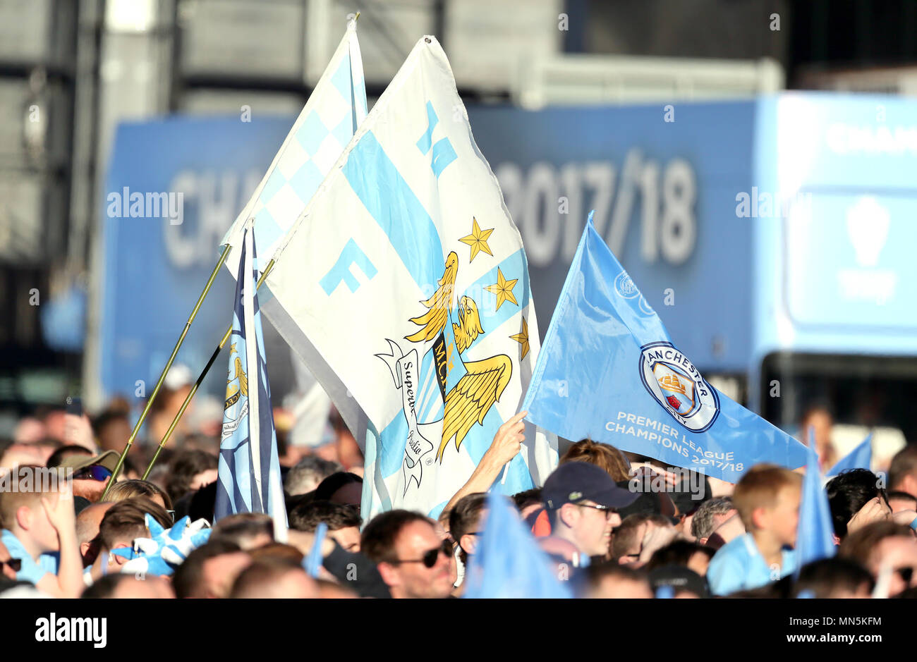 Manchester City fans waving flags during the Premier League champions trophy parade, Manchester. Stock Photo