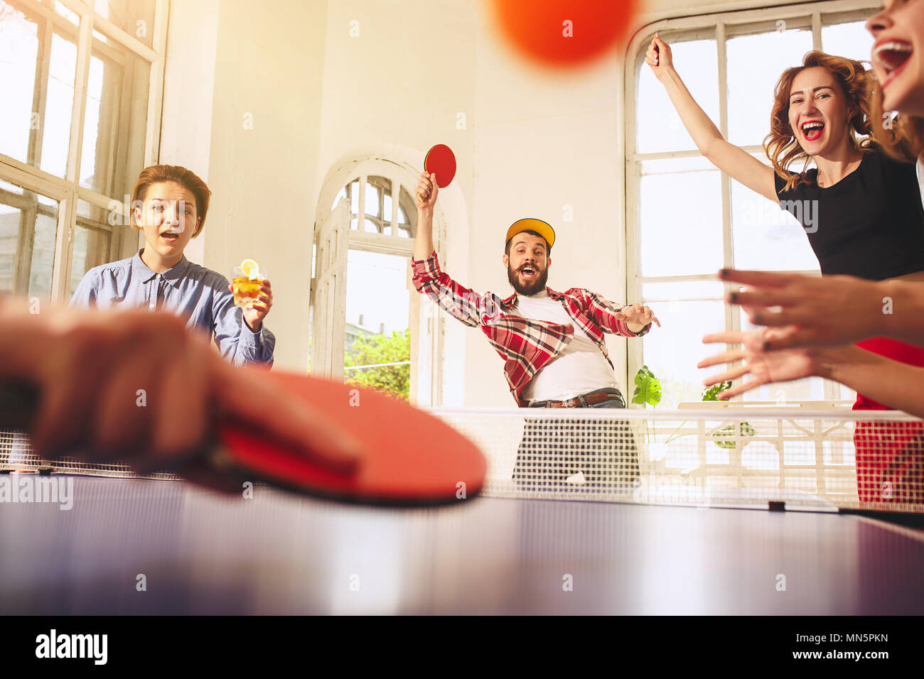 Group of happy young friends playing ping pong table tennis Stock Photo Alamy