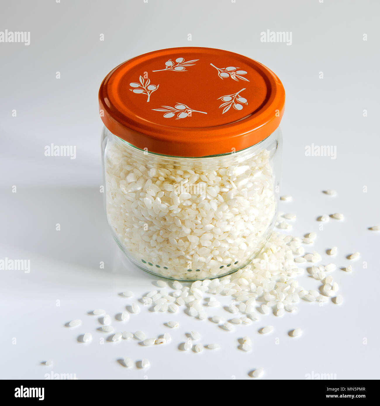 Rice in a glass jar on white background Stock Photo