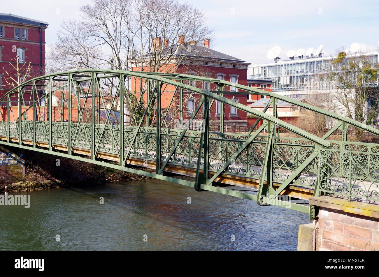 Elegant green-painted iron footbridge built in 1889 across the river Ill , in Strasbourg, after locals petitioned for its construction. Stock Photo