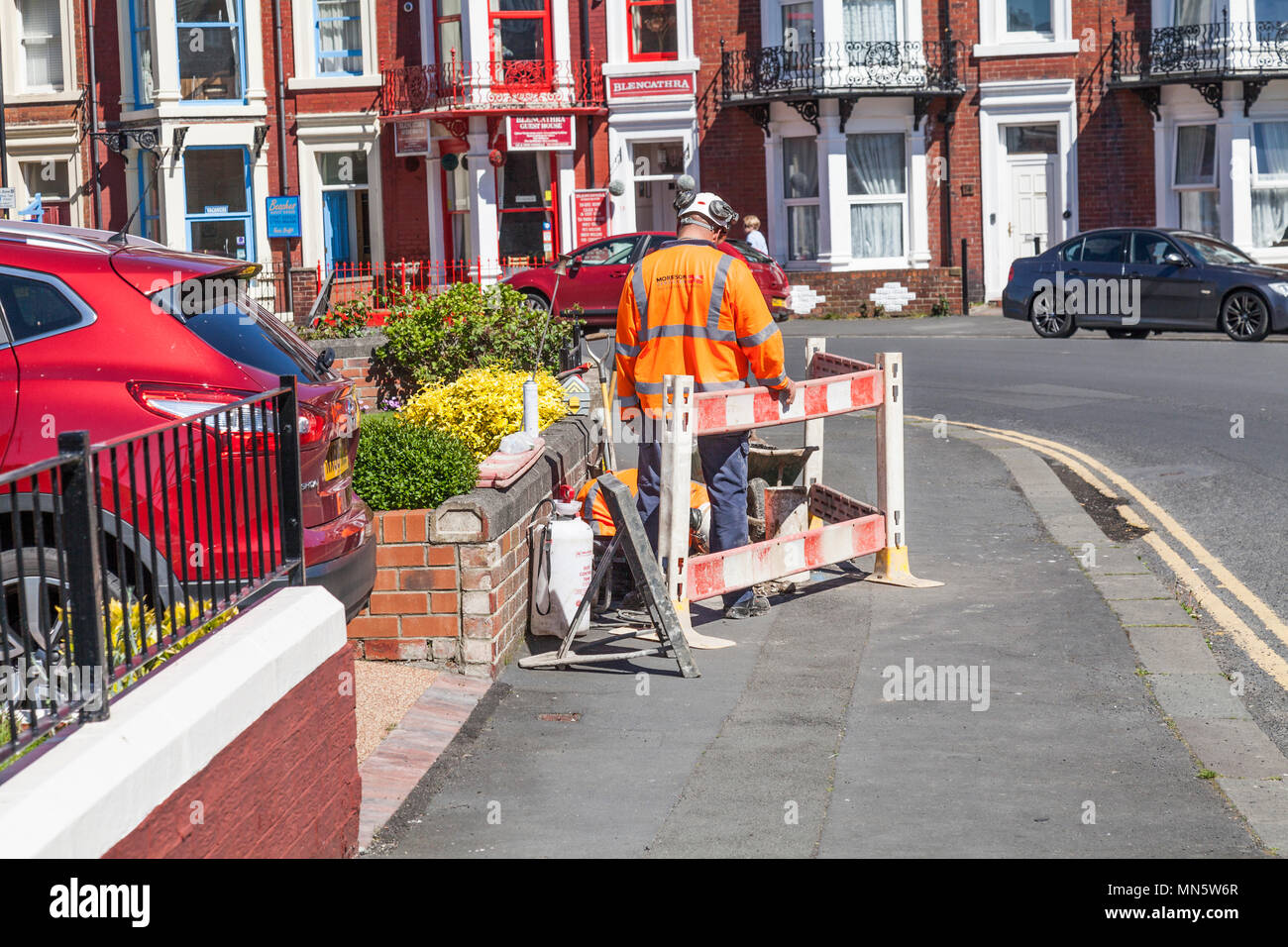 Men working on the pavements at Whitby, North Yorkshire, England, UK Stock Photo