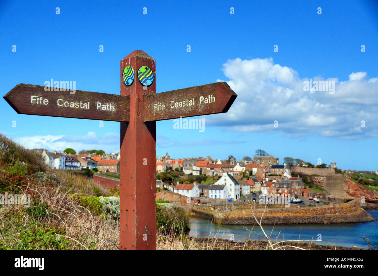 Fife coastal path signpost with Crail harbour in the background Stock Photo