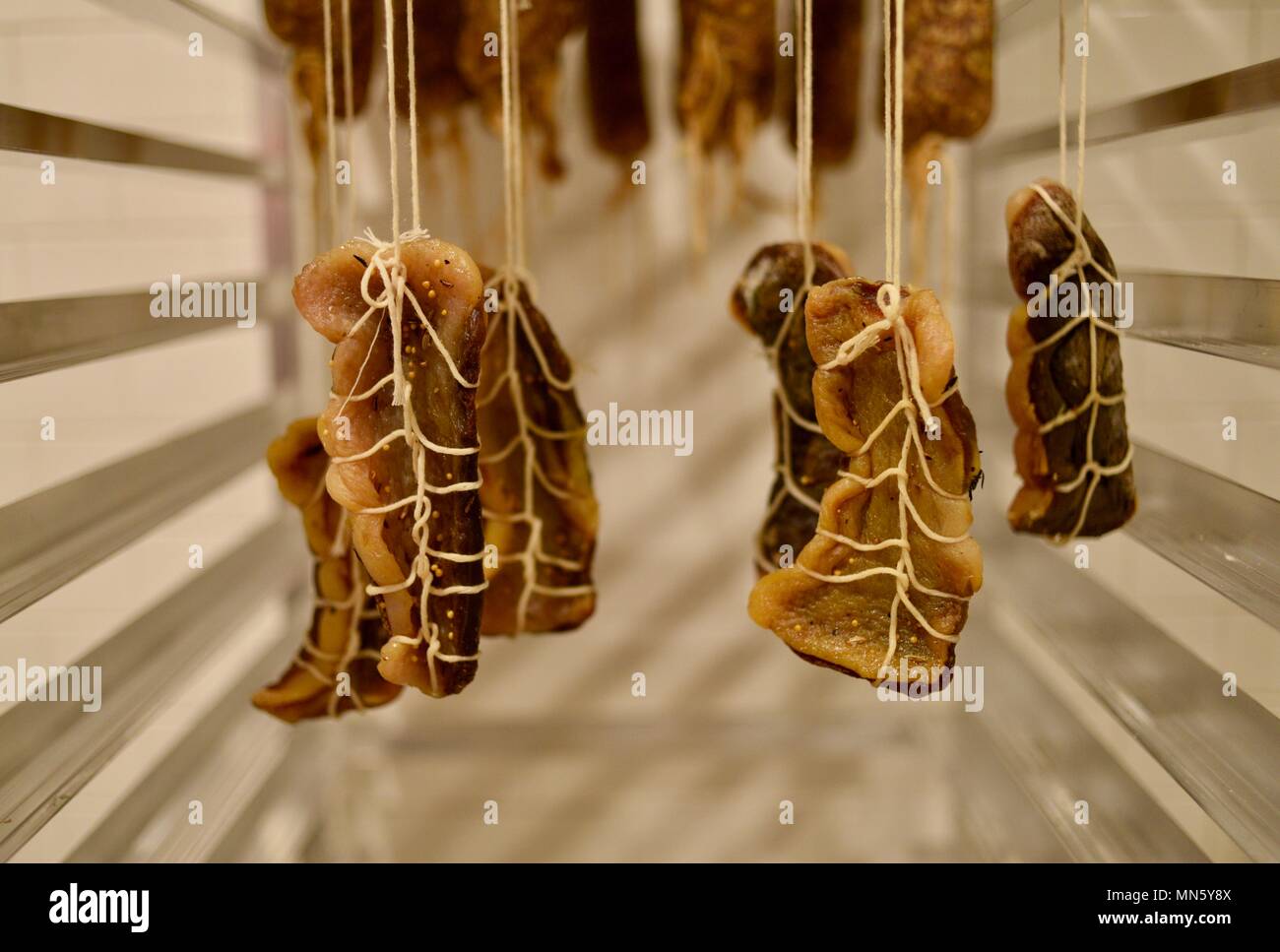 Sausage hanging and curing, house made, gourmet cured heritage Texas