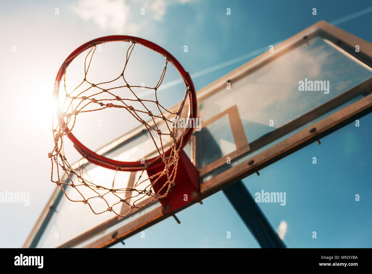 Sunlight shining through basketball hoop with net Stock Photo