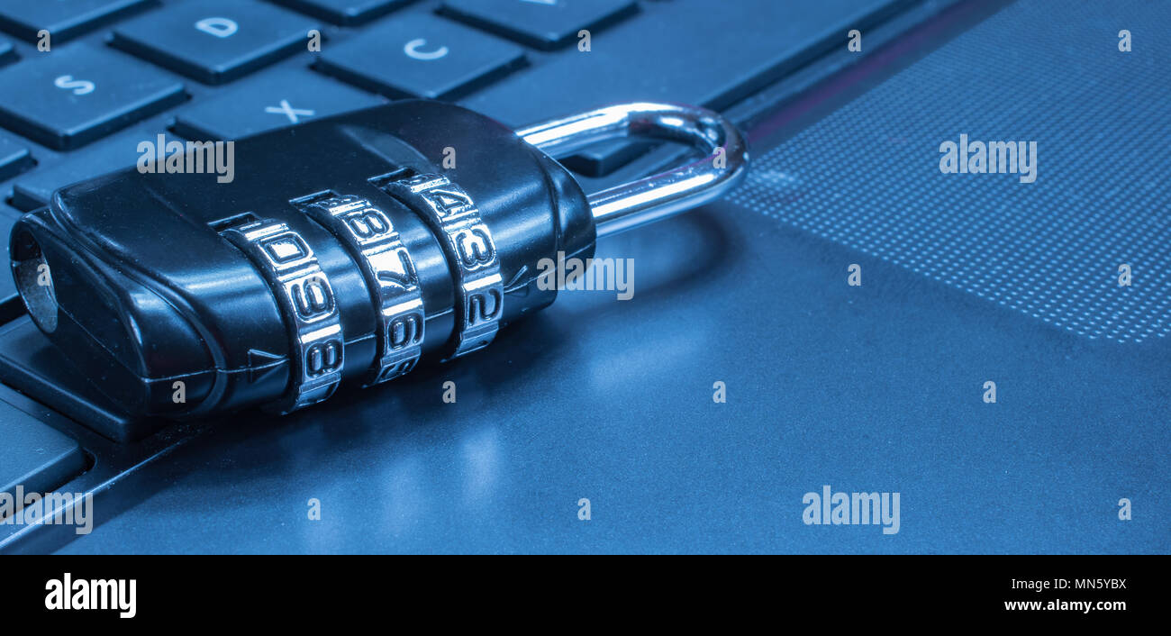 Network Security: Lock on computer keyboard. Blue tone. Stock Photo