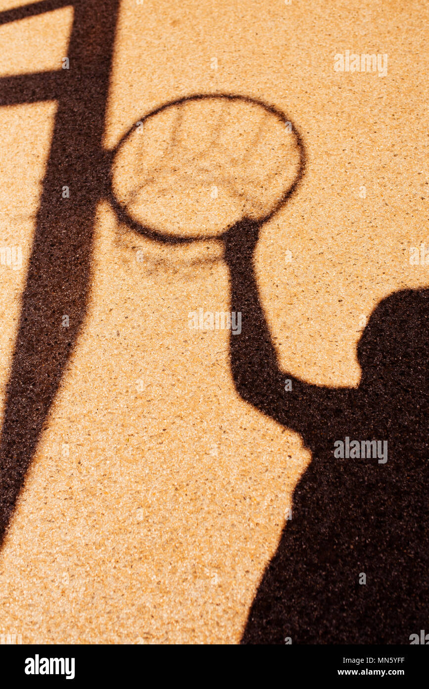Shadow of male basketball player in slam dunk pose, holding the hoops Stock Photo