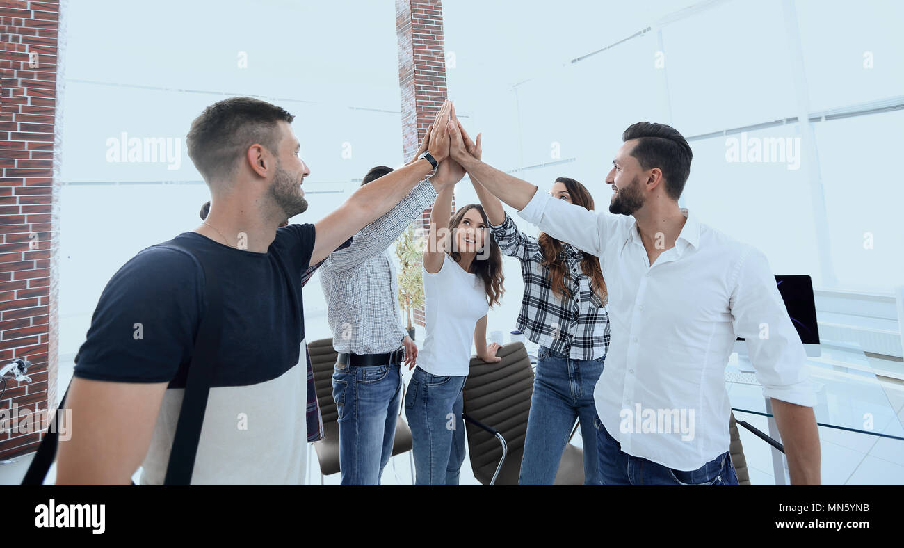 creative team giving each other a high five Stock Photo - Alamy