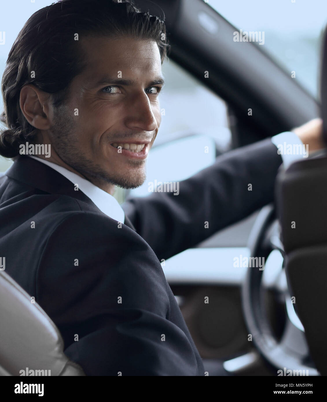 man sitting behind the wheel of a car Stock Photo - Alamy