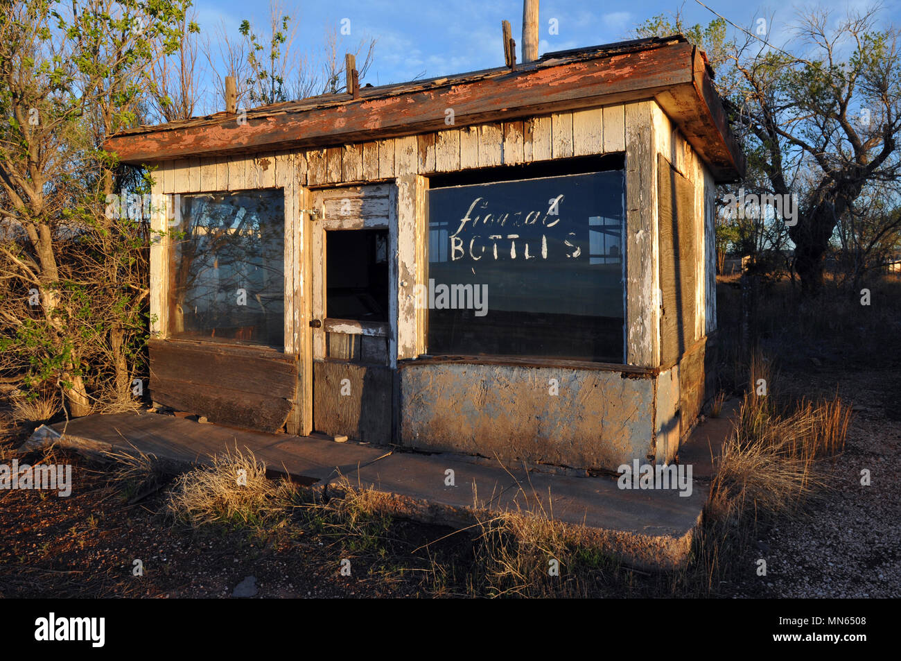 An abandoned shop that once sold figural bottles stands in the Route 66 town of Newkirk, New Mexico. Stock Photo