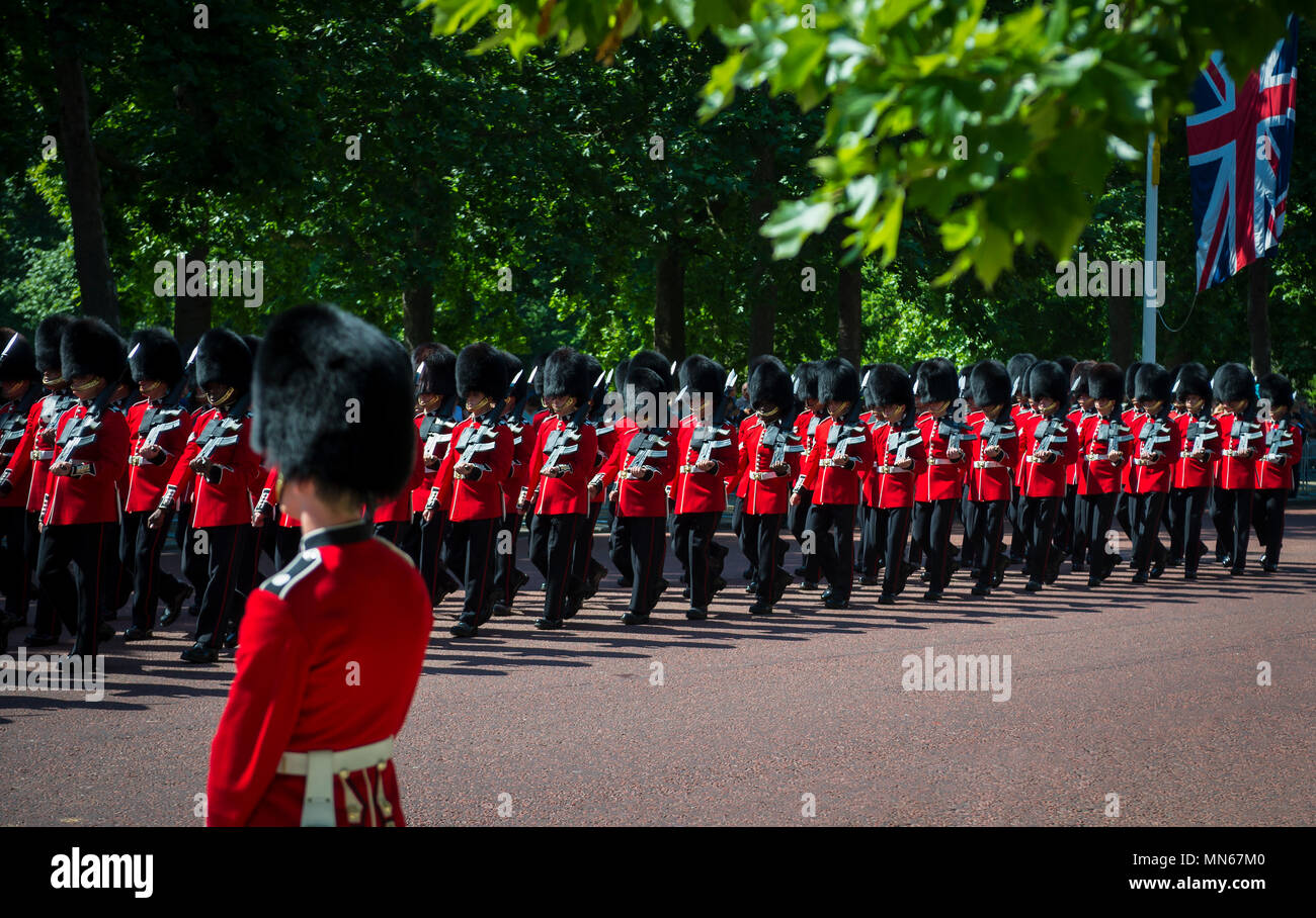 LONDON - JUNE 17, 2017: Queens guard in traditional red coats and bear fur busby hats march in formation on the Mall in a Trooping the Colour parade Stock Photo