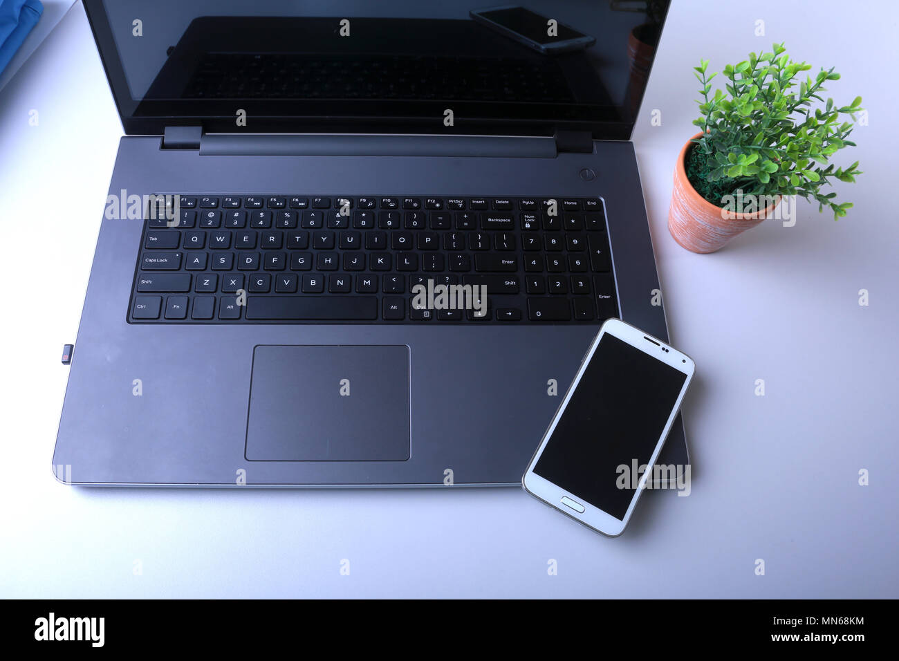 Office workplace with laptop, smart phone on table Stock Photo