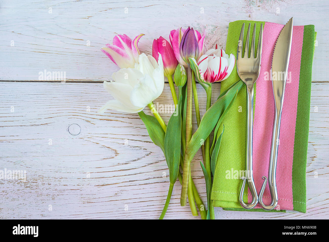 Table setting with fresh tulips Stock Photo