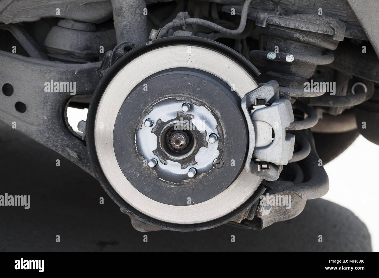 Closeup photo of brake disk and suspension springs. Replacing wheel on