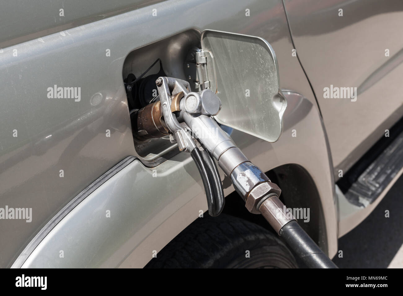 LPG filling of modern SUV car on a gas station Stock Photo