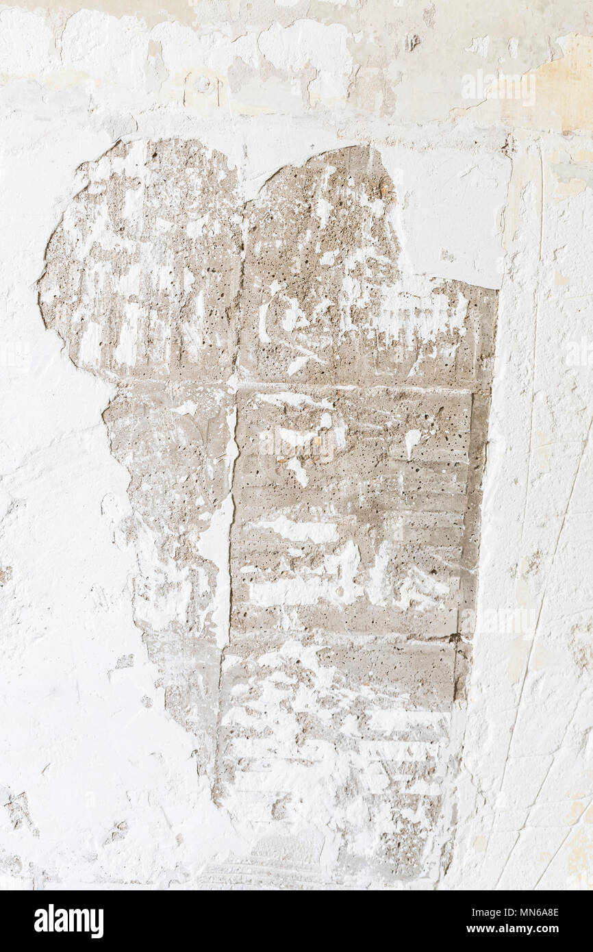 Textured ragged white wall plaster, after taking out tile. The wall ...