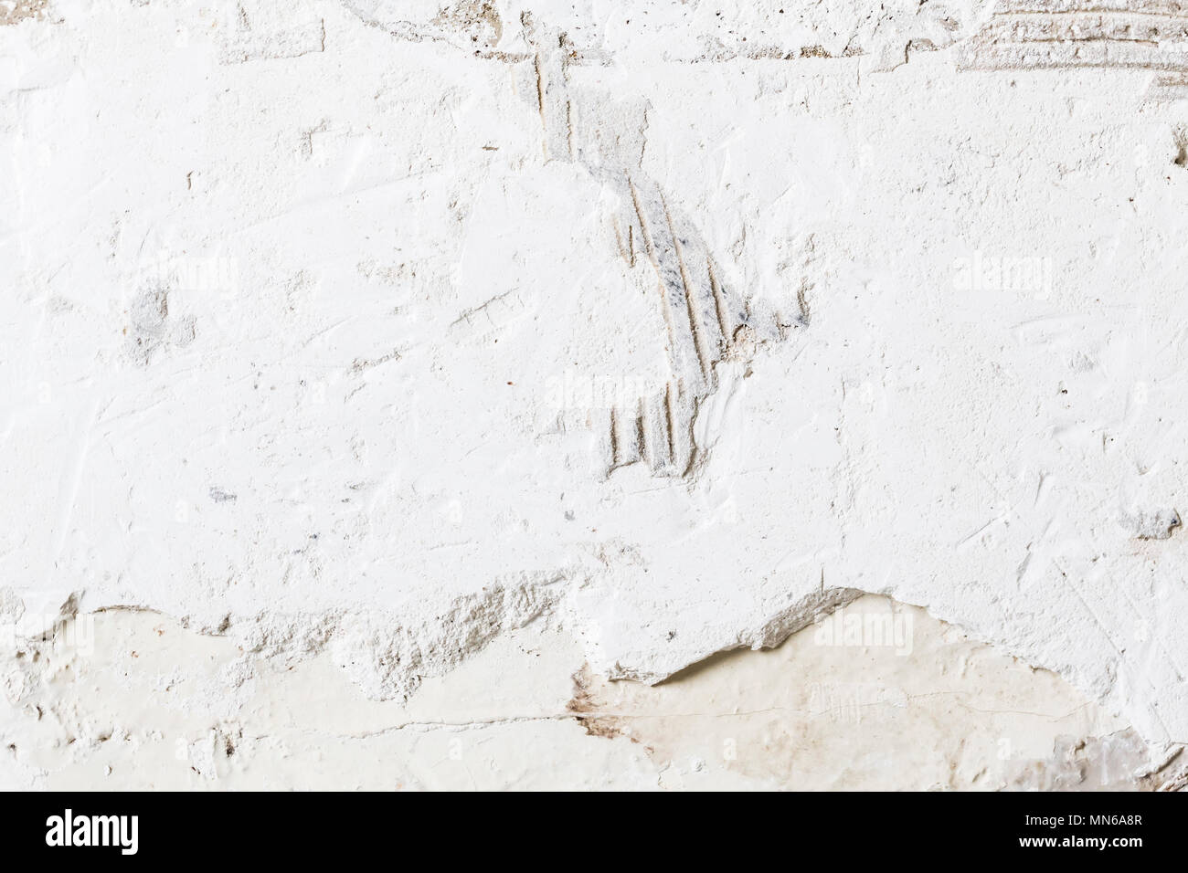 Textured ragged white wall plaster, after taking out tile. The wall ...
