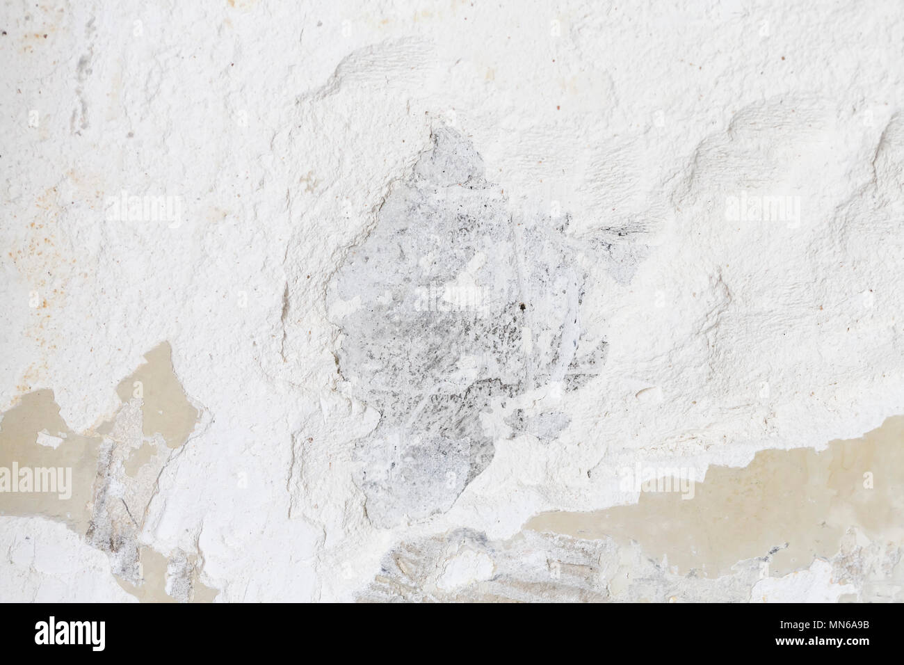 Textured ragged white wall plaster, after taking out tile. The wall ...