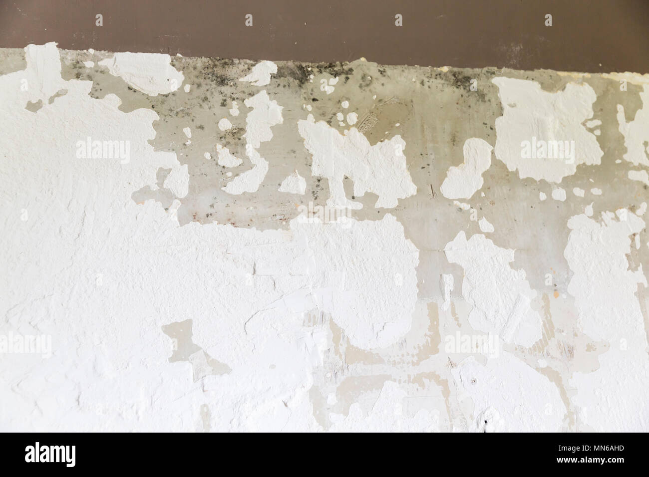 Textured ragged white wall plaster, after taking out tile. The wall ...