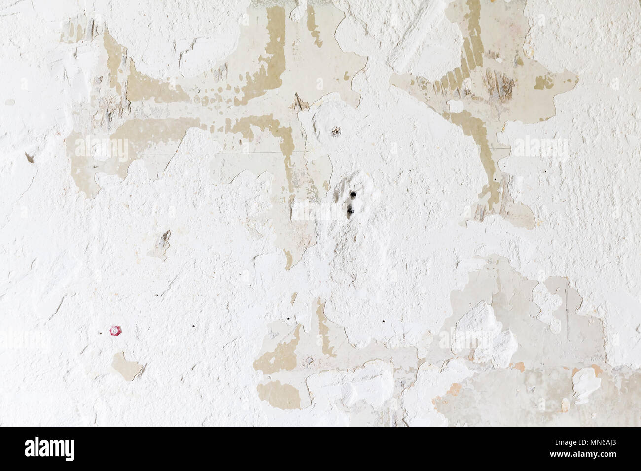 Textured ragged white wall plaster, after taking out tile. The wall ...