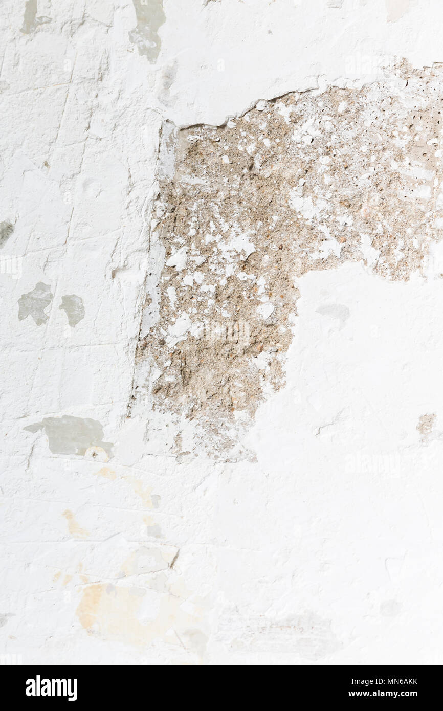 Textured ragged white wall plaster, after taking out tile. The wall ...