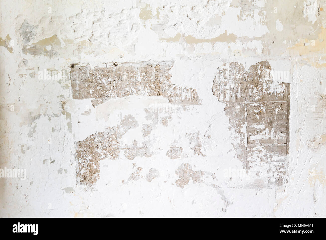 Textured ragged white wall plaster, after taking out tile. The wall ...