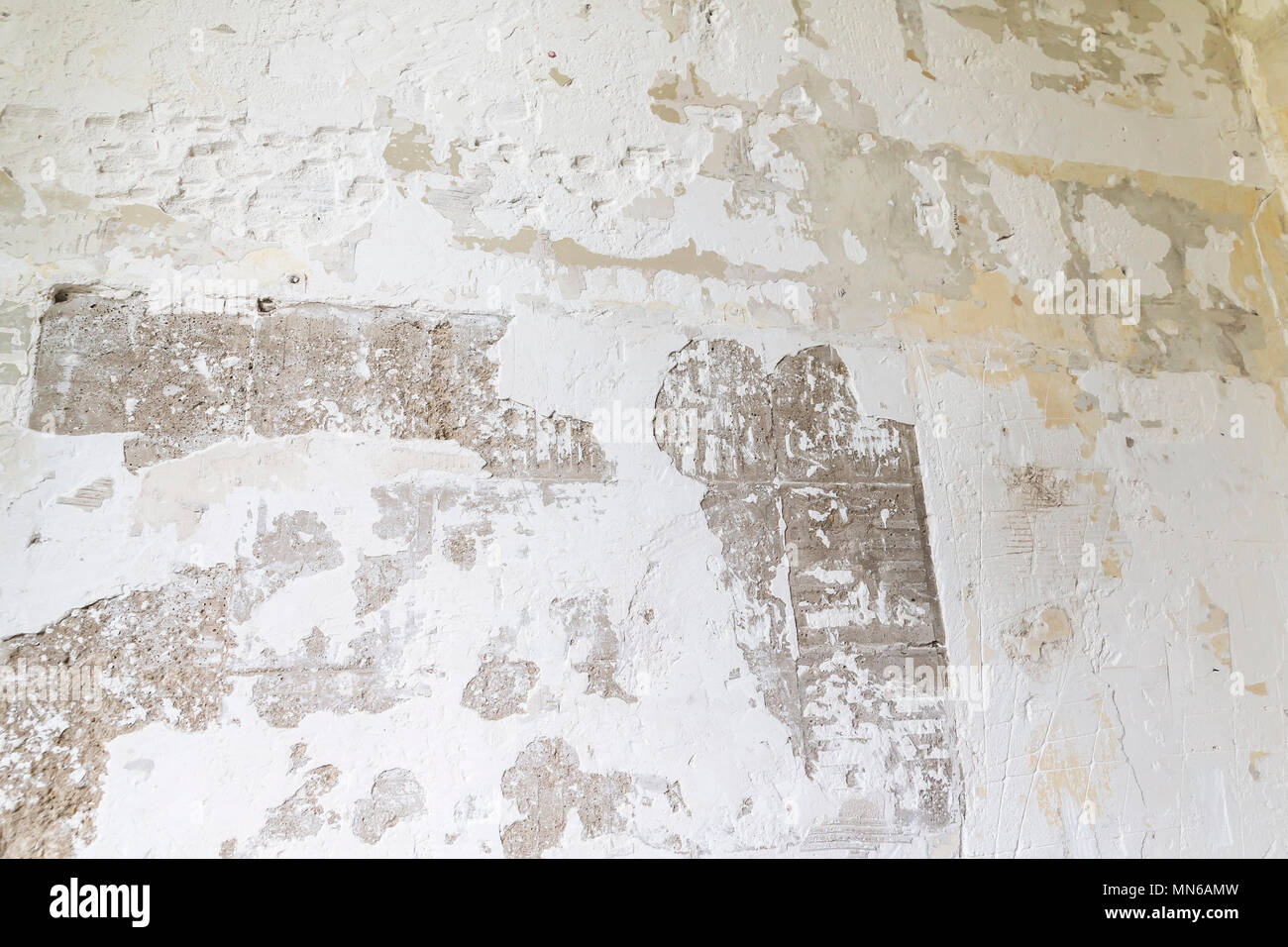 Textured ragged white wall plaster, after taking out tile. The wall ...