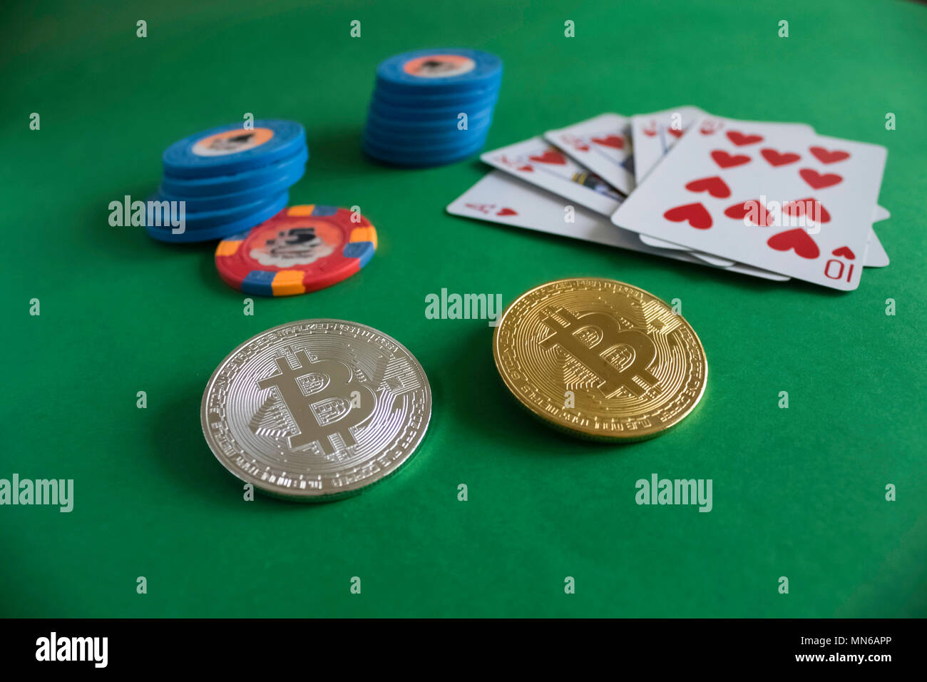 Bitcoin gold coin with poker chips on a green poker table against black  background. Blockchain casino. Online gambling Stock Photo - Alamy