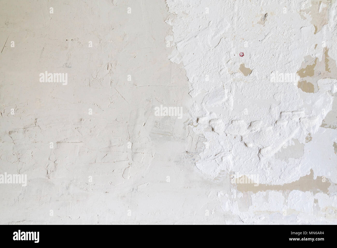 Textured ragged white wall plaster, after taking out tile. The wall ...