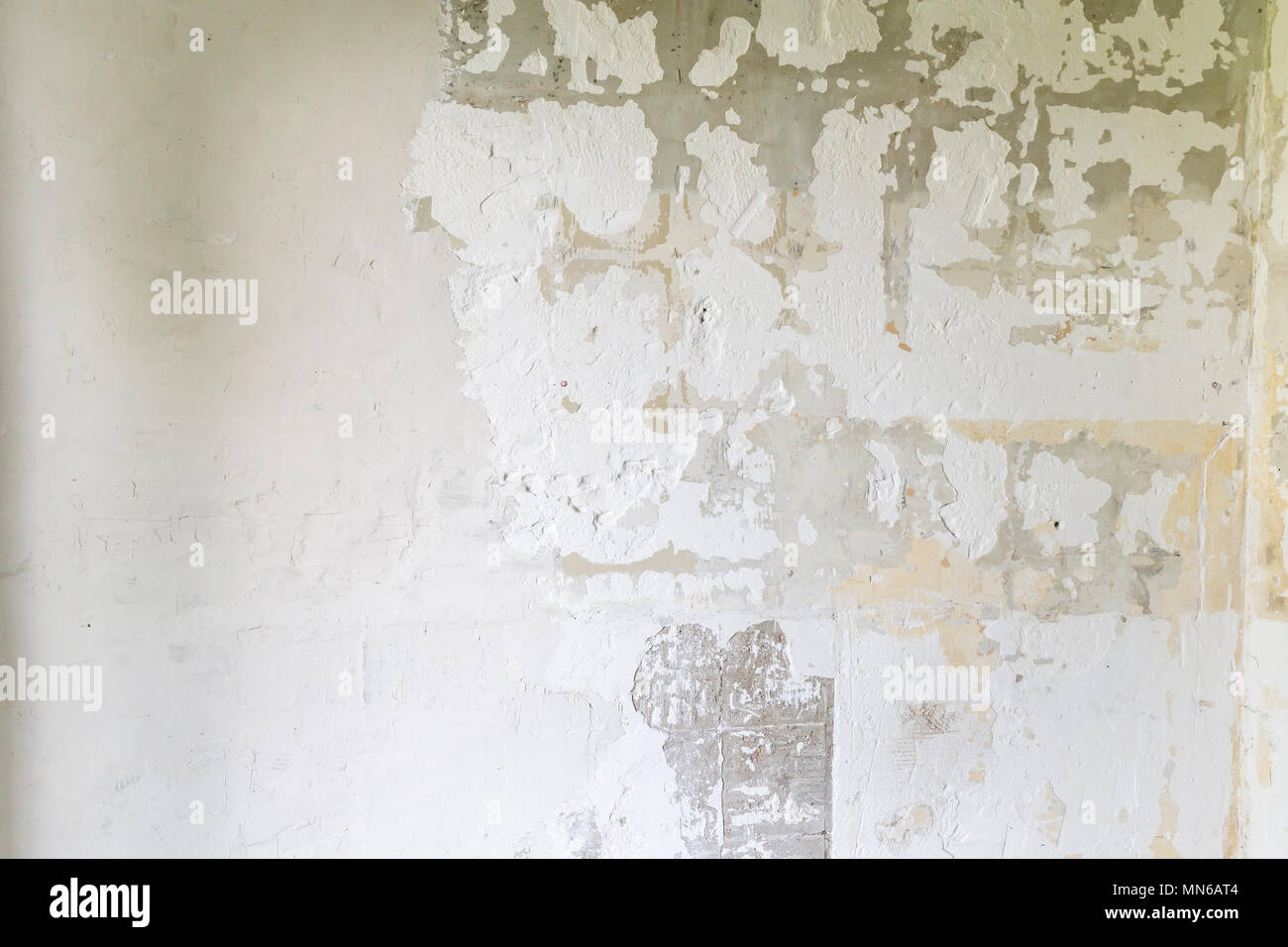 Textured ragged white wall plaster, after taking out tile. The wall ...