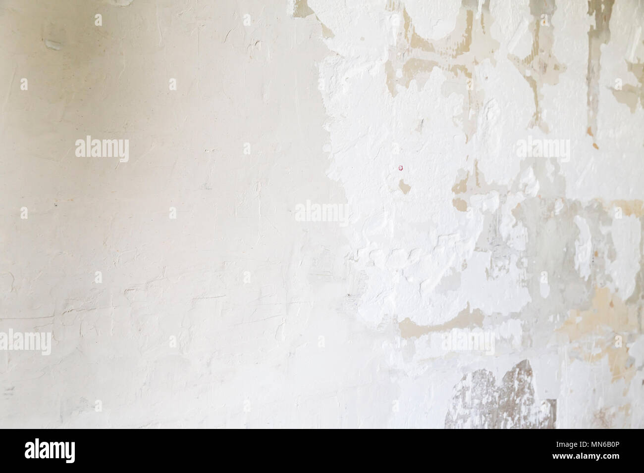 Textured ragged white wall plaster, after taking out tile. The wall ...