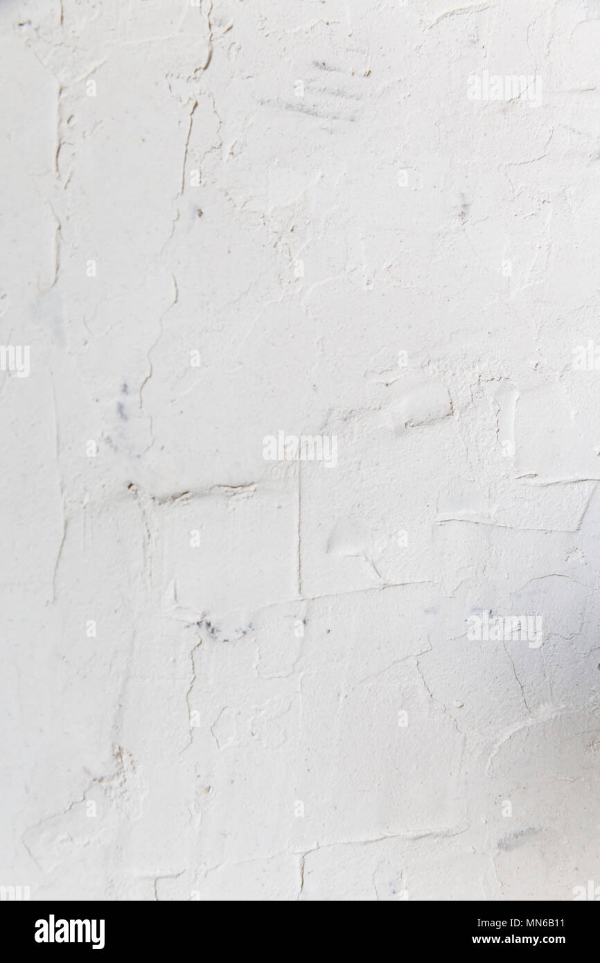 Textured ragged white wall plaster, after taking out tile. The wall ...