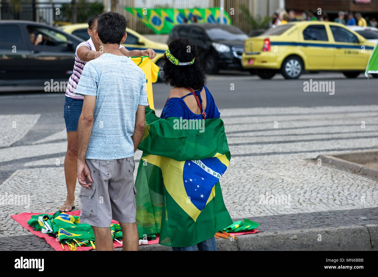Copacabana beach, Rio de Janeiro - April 17, 2016: Street vendors sell the national flags of Brazil during a protest against president Dilma Rousseff Stock Photo