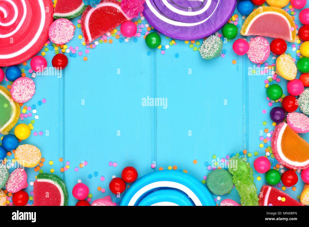 Frame of assorted colorful candies against a blue wood background Stock Photo