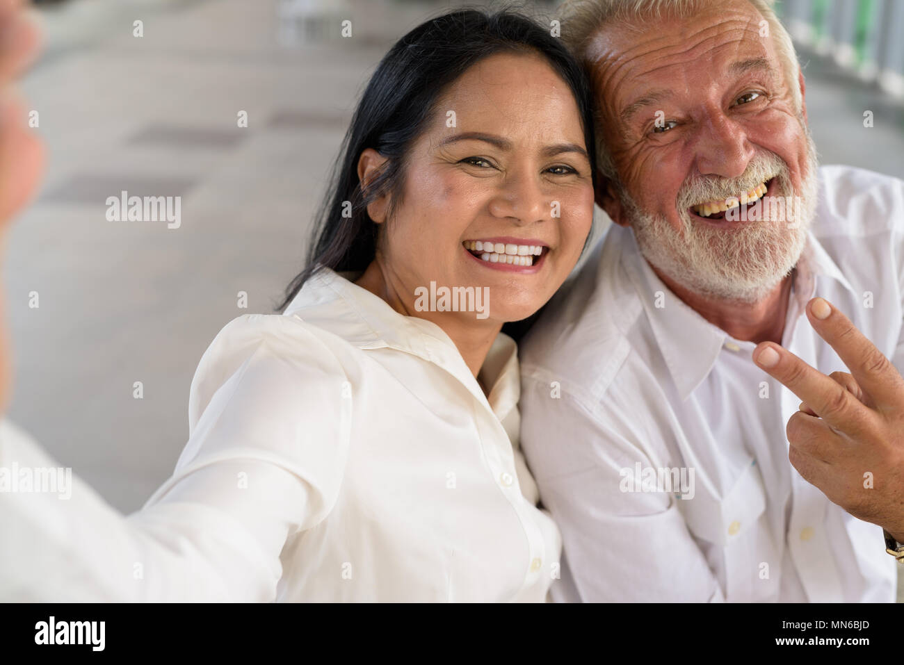 Mature multi-ethnic couple happy and in love while exploring the Stock Photo