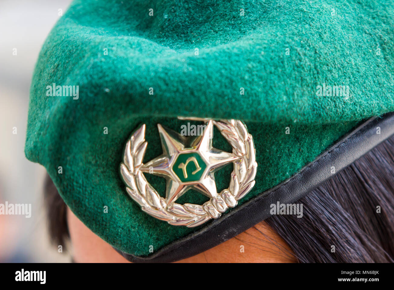 12 May 2018 Via Dolorosa Jerusalem Israel A friendly young Israeli police woman poses for a close up photograph of her cap badge. Stock Photo