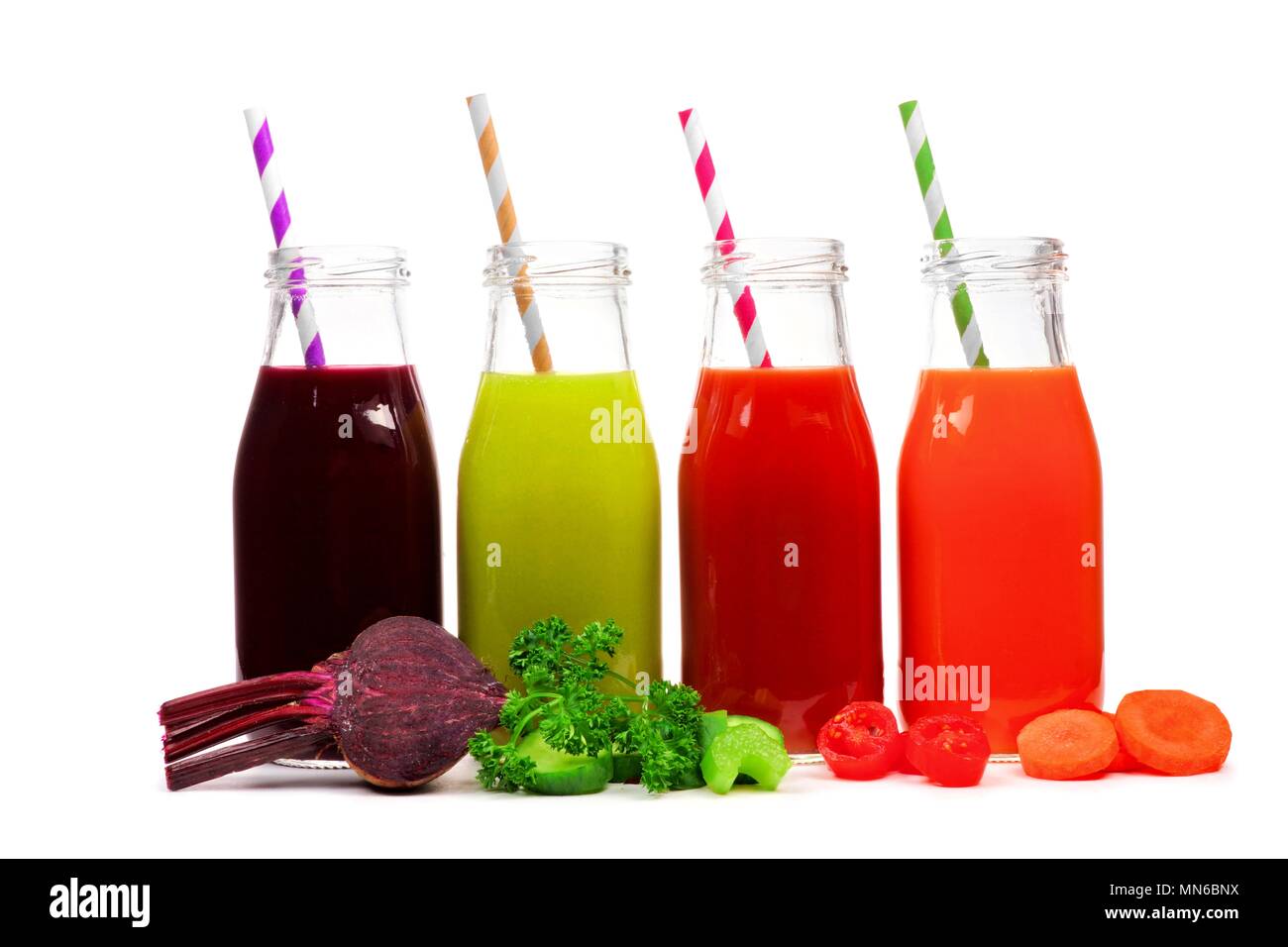 Four bottles of vegetable juice, beet, greens, tomato, and carrot ...