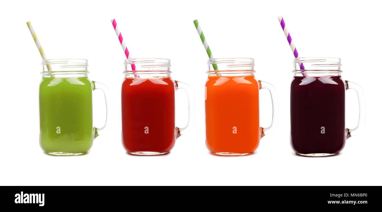 Four mason jar glasses of vegetable juice, greens, tomato, carrot and beet, isolated on a white background Stock Photo